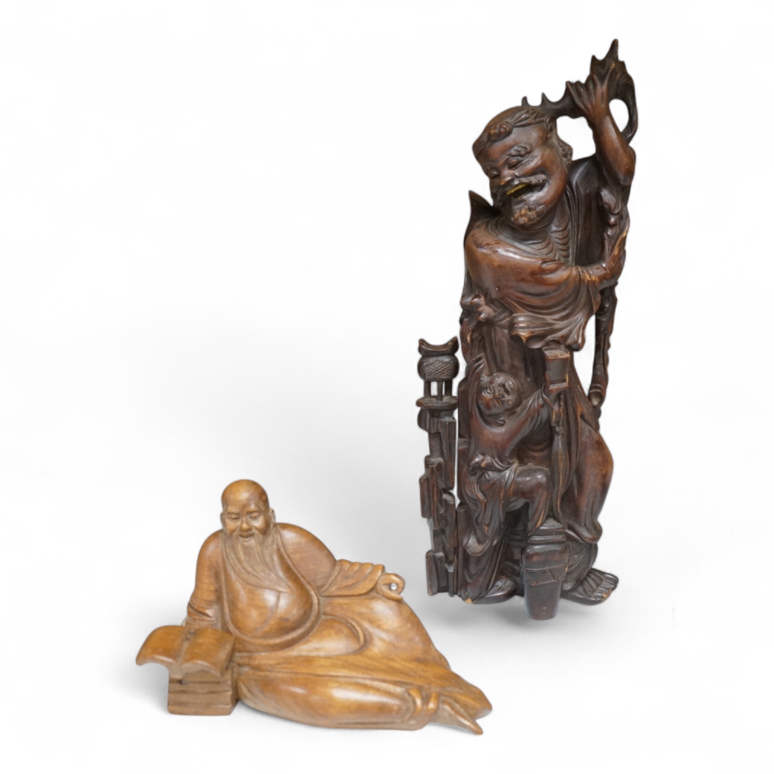 A Chinese root carving of a luohan and another of a reclining monk, largest 26cm high (2)